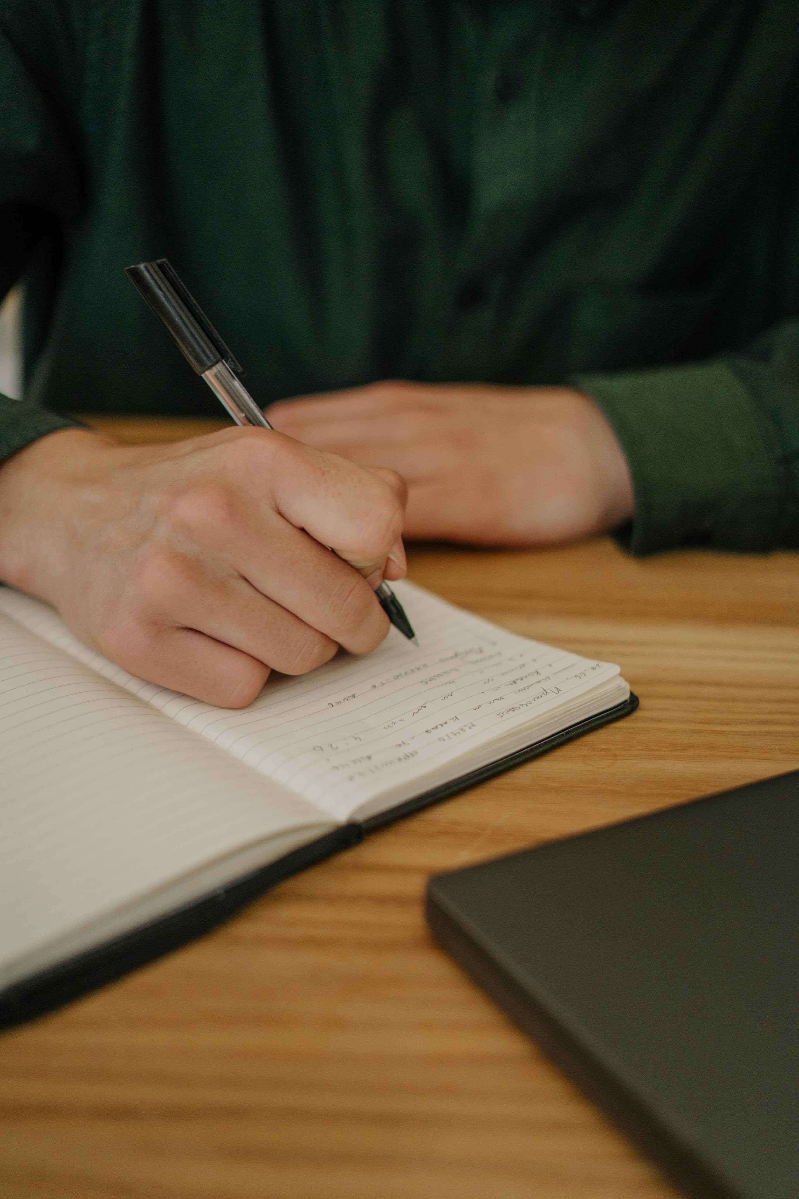 Person writing in notebook